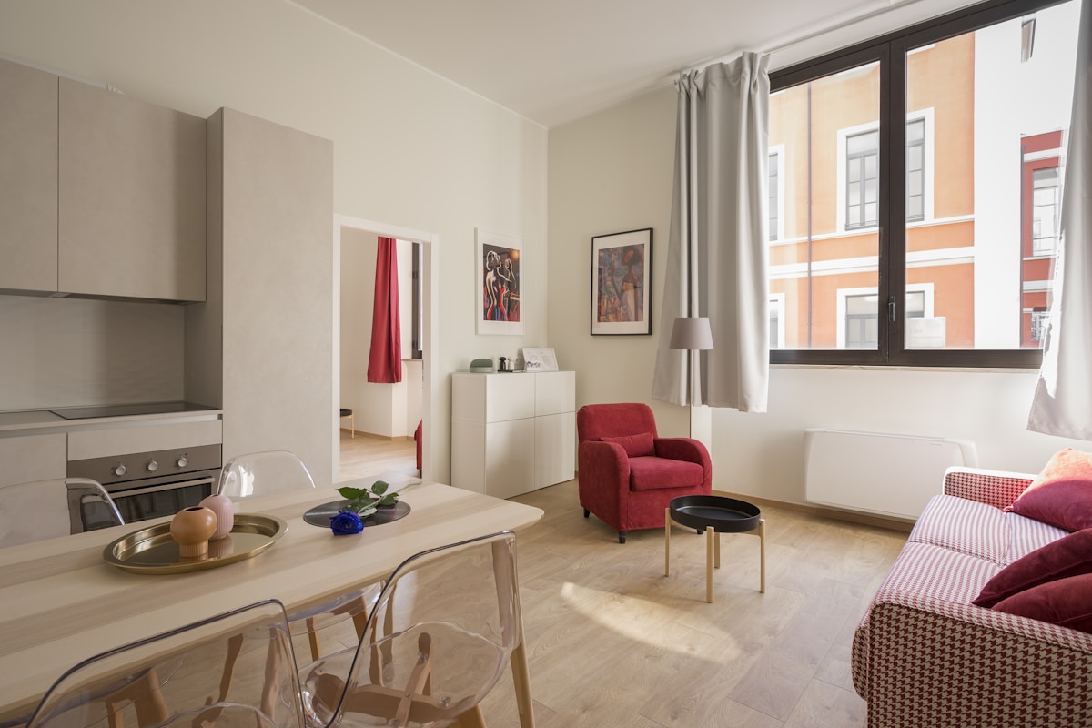 Modern interior with floor-length grey curtain fabric at the window