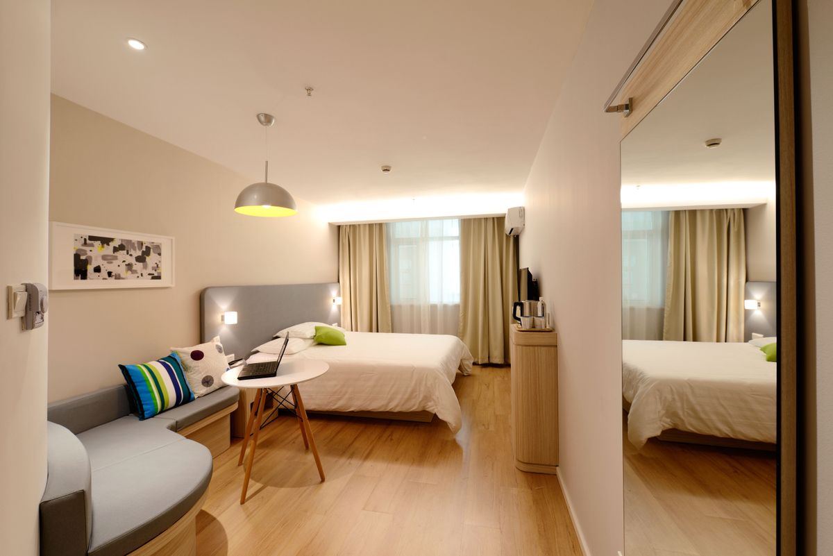 Hotel guest room with layered curtain and sheer window dressings