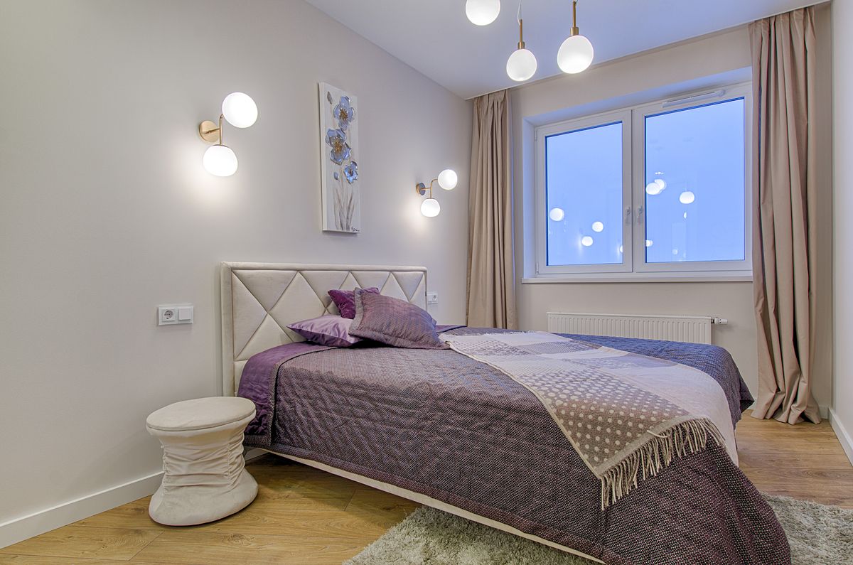 Residential bedroom with full-height curtain panels framing the window