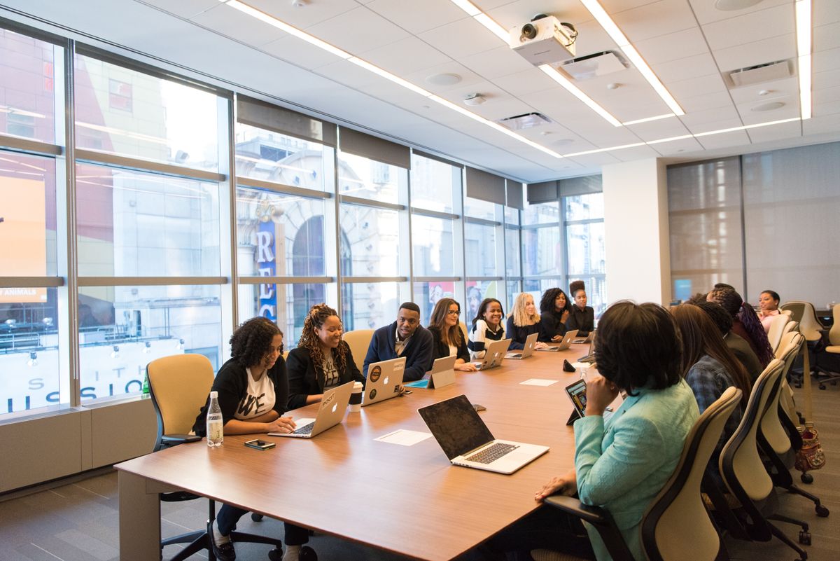 Meeting room with roller shade fabric lowered on floor-to-ceiling windows